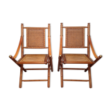 Pair of folding chairs in bamboo and caning, leather and brass