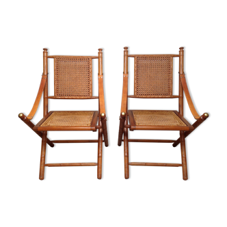 Pair of folding chairs in bamboo and caning, leather and brass