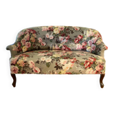 Napoleon III canapé upholstered in floral patterned fabric.