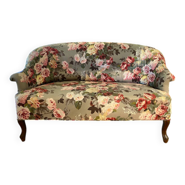 Napoleon III canapé upholstered in floral patterned fabric.