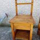 2 old wooden children's chairs with a small chest.