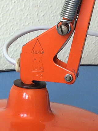 Luxo L9 orange single-arm lamp on plinth