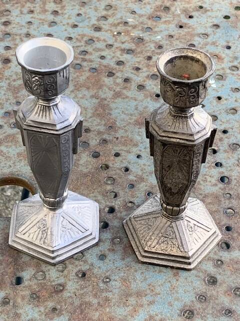 Pair of metal candlesticks, chiseled with a statuette in front, rose pattern in relief, art deco