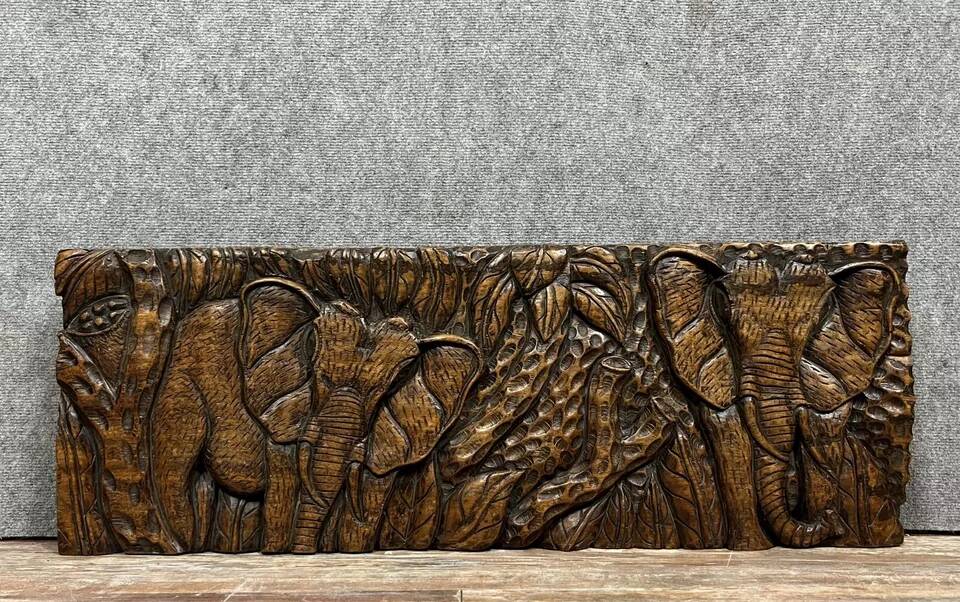 Central Africa 20th century: carved wooden panel in bas-relief of elephants