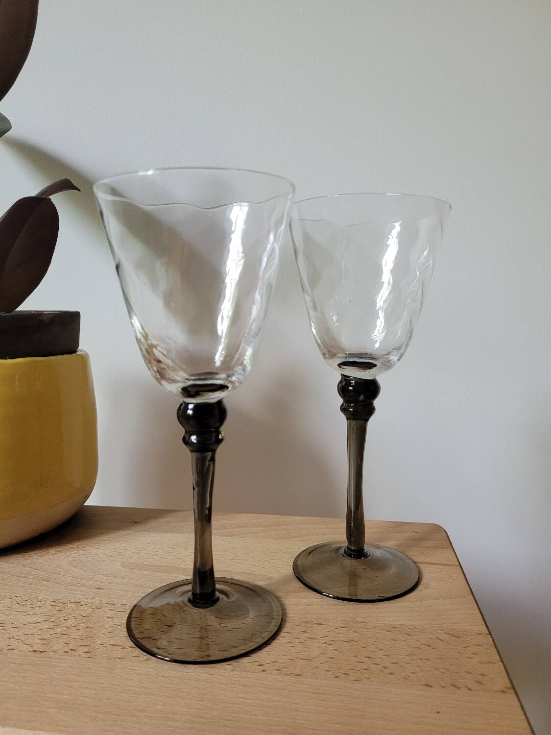 Two smoked black stem wine glasses
