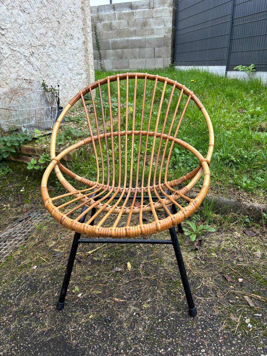 Vintage rattan armchair with metal legs