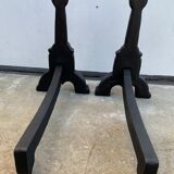 Pair of cast iron chenets with stylized faces High Epoch SEVENTEENTH century