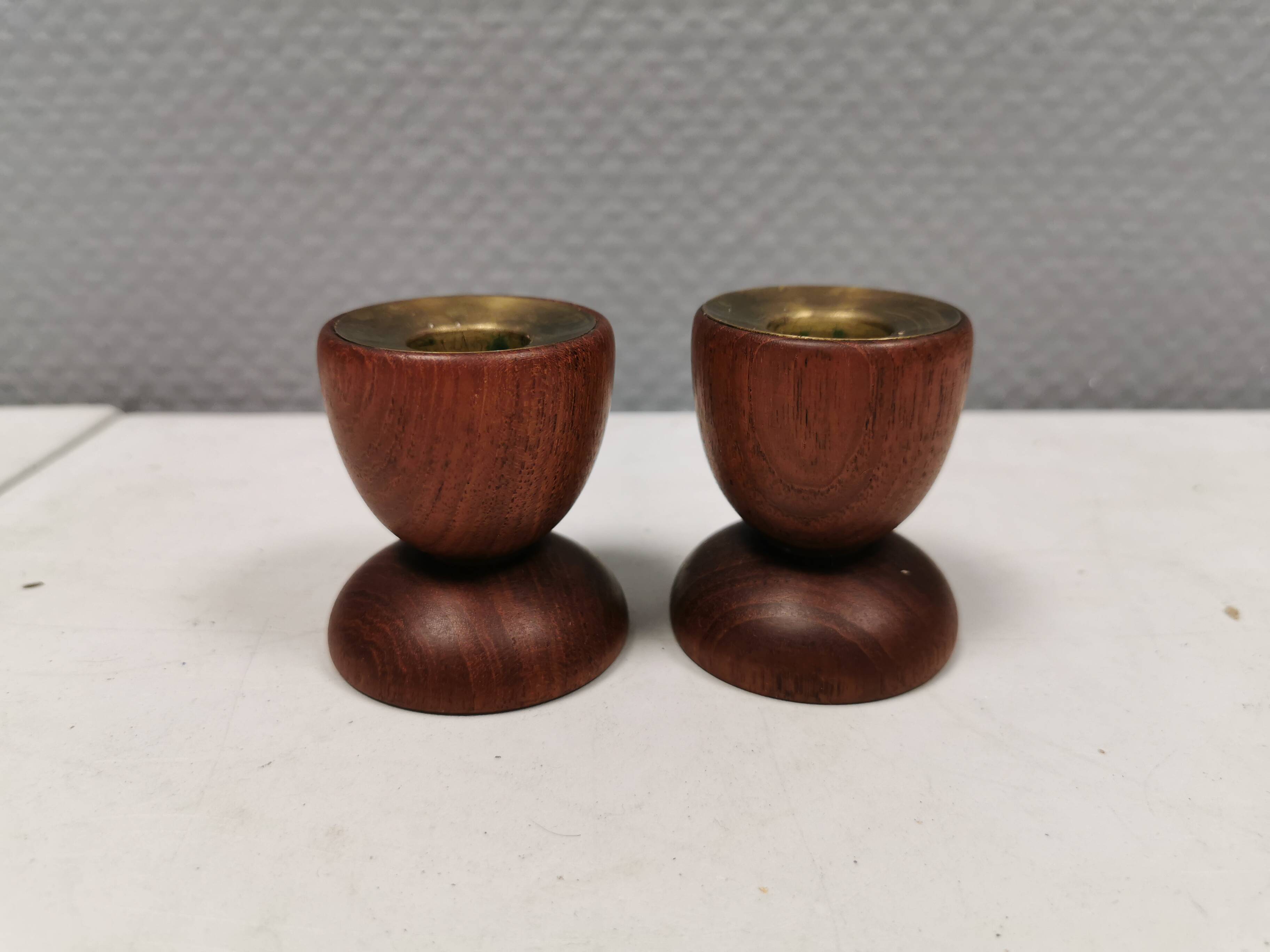 Two beautiful teak candle holders with brass inserts.