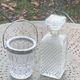 Whiskey carafe and ice bucket in transparent glass and silver-colored metal handle