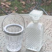 Whiskey carafe and ice bucket in transparent glass and silver-colored metal handle