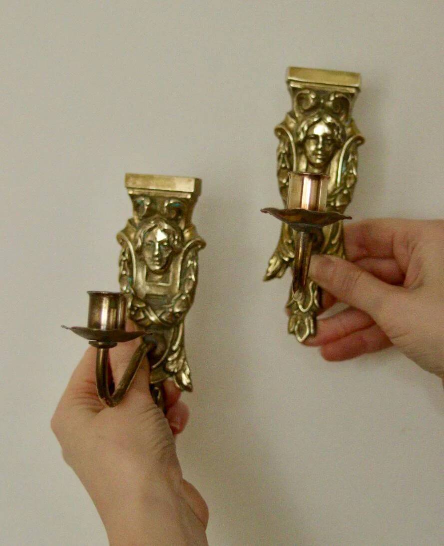 Pair of mid-century Swedish brass face motif sconces