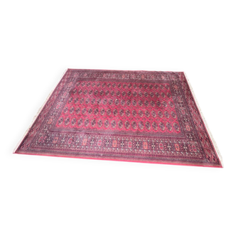 Large red Bokhara-style oriental carpet 300x200 cm with gul patterns.