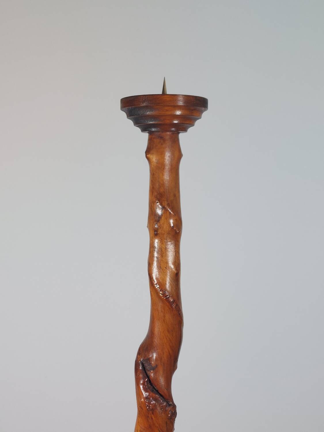 Vintage candle holder in an organic shape with a brass spike and tiered top.