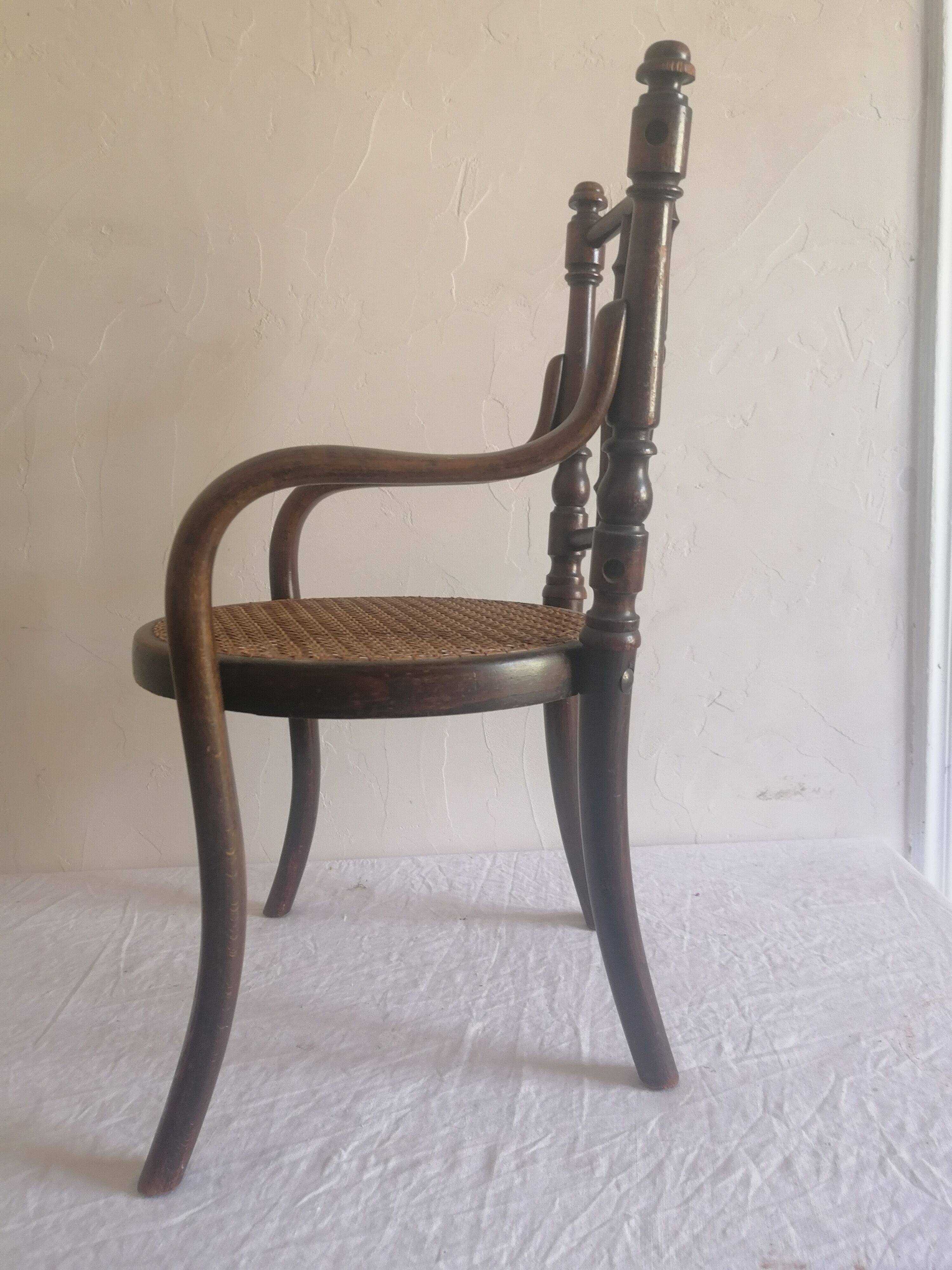 Old children's armchair in curved wood. Fischel