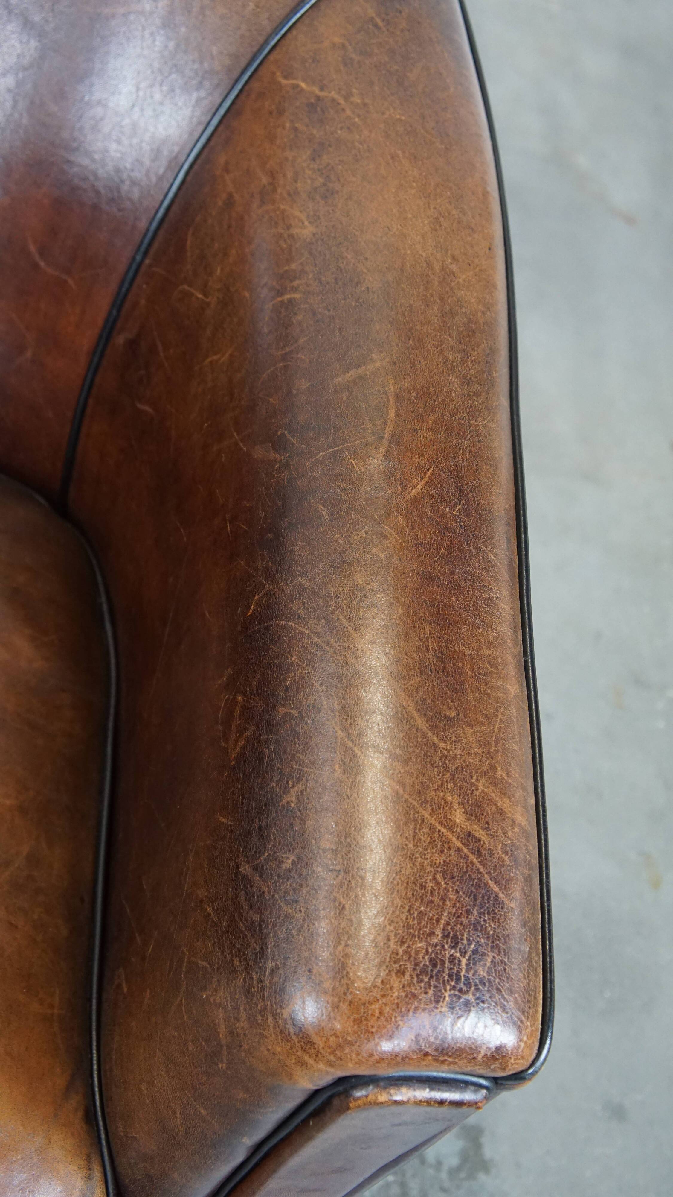 Sheep leather club chair finished with black piping