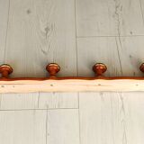 Wall-mounted coat rack in wood and brass