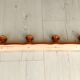 Wall-mounted coat rack in wood and brass