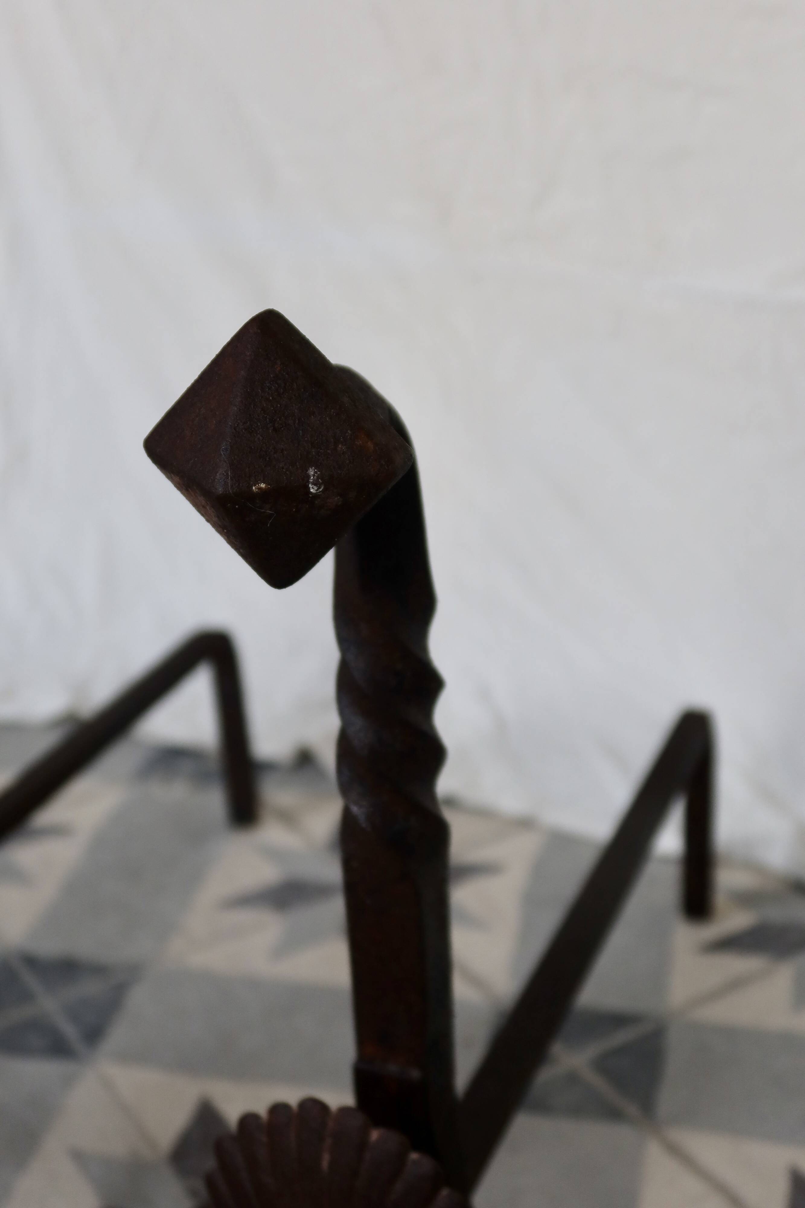 Vintage metal and cast iron fire dogs with shell motif.