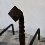 Vintage metal and cast iron fire dogs with shell motif.