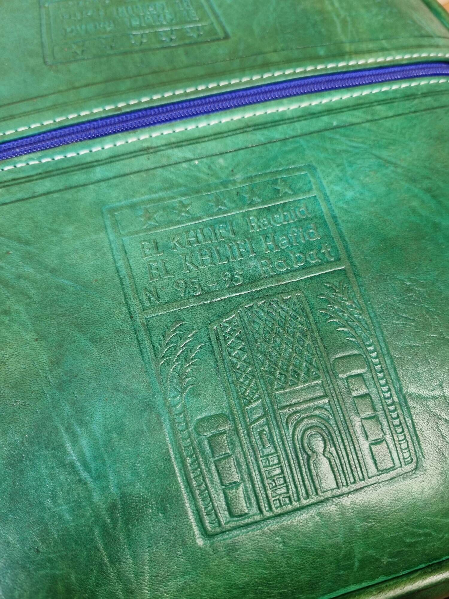 Pair of Moroccan poufs in stamped leather with a carved wooden base, Rabat