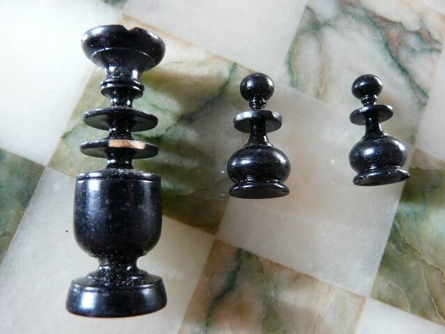 Onyx chessboard and complete wooden chess set.