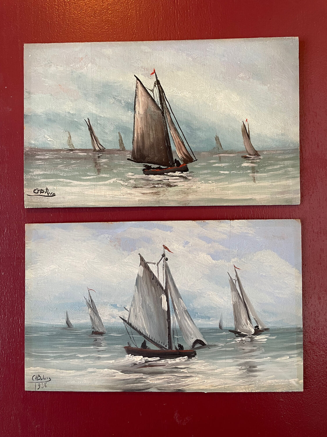 A pair of old paintings on wood.