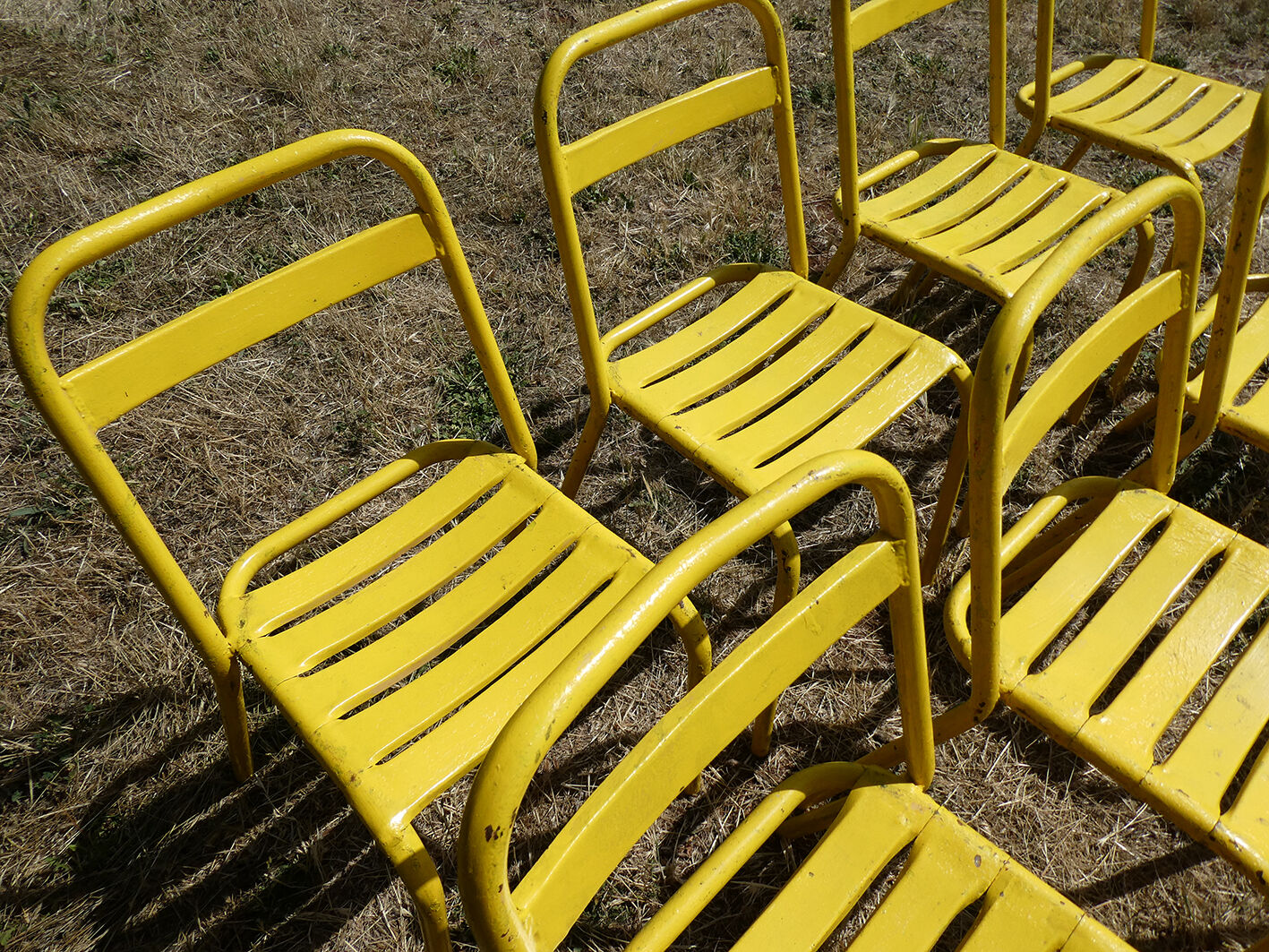 Lot of 11 yellow metallic bistro chairs from the 1950s