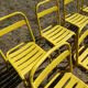 Lot of 11 yellow metallic bistro chairs from the 1950s