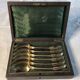 Vermeil (gilded silver) spoons in black wooden box