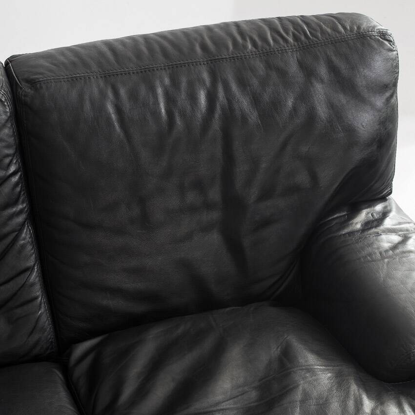 Black leather two-seater sofa. Roche Bobois edition. France, 1980s.