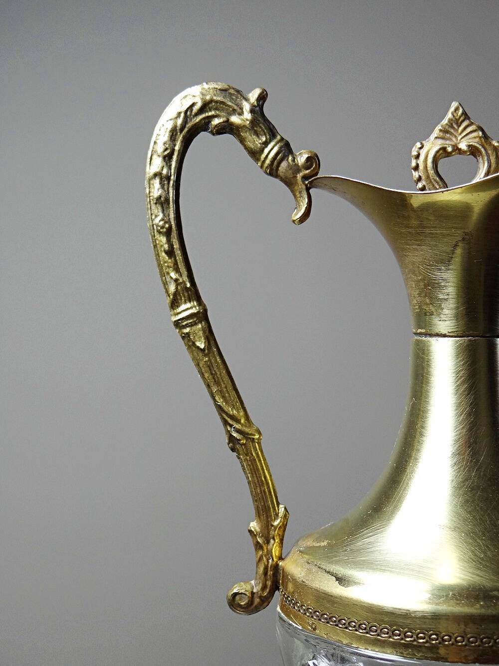 Vintage decorative jug in moulded glass and gilded brass, Italy circa 1980.