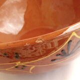 Red terracotta salad with black and yellow patterns