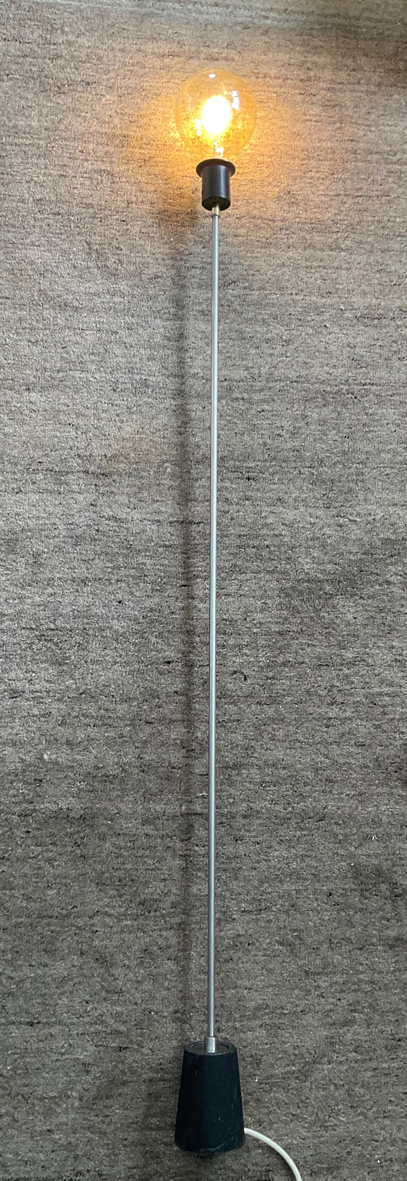 Minimalist floor lamp in cast iron and chrome metal