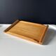 Vintage wooden plateau in Scandinavian style from the 60s — cylindrical handles.
