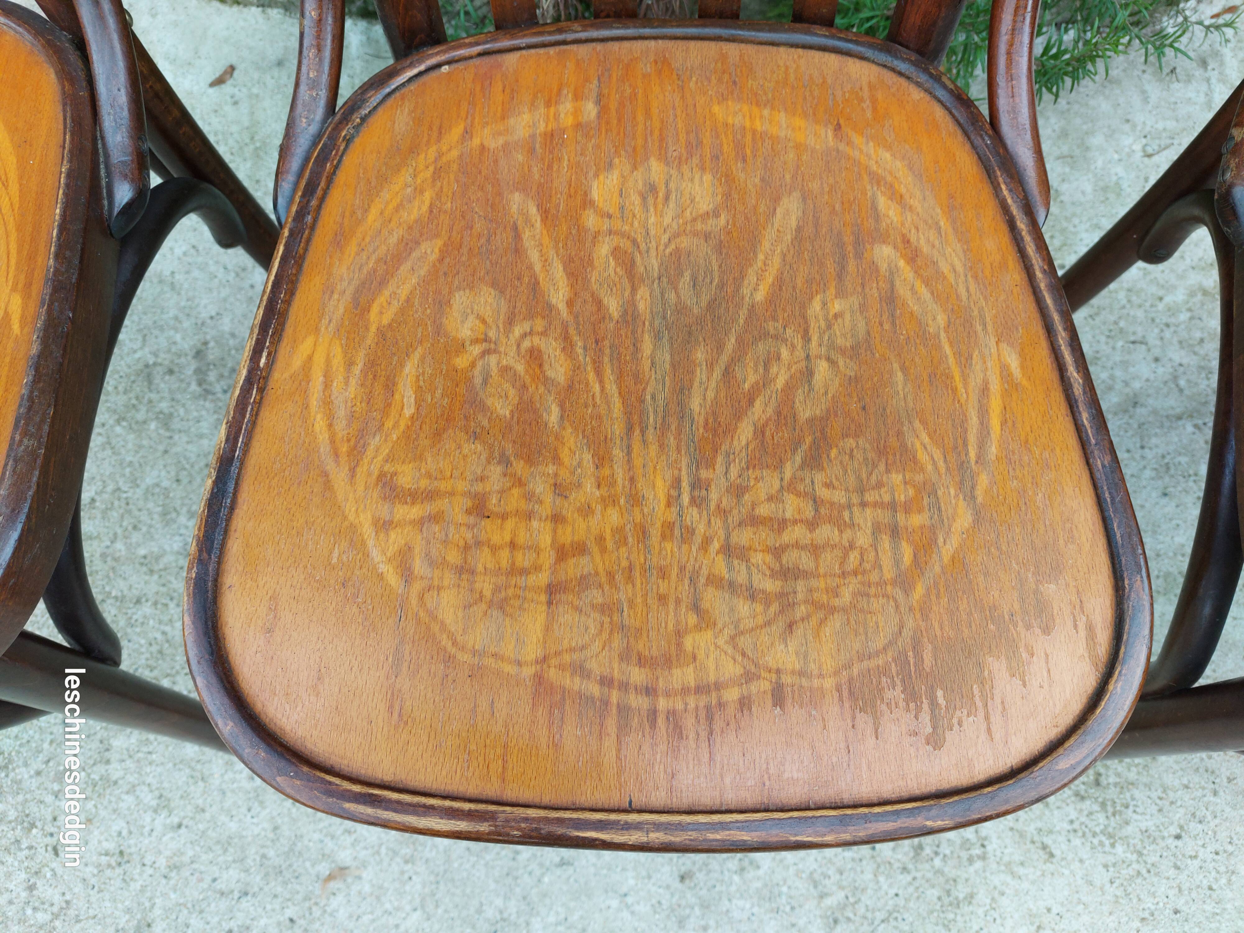 4 bentwood bistro chairs with a pattern on the seat