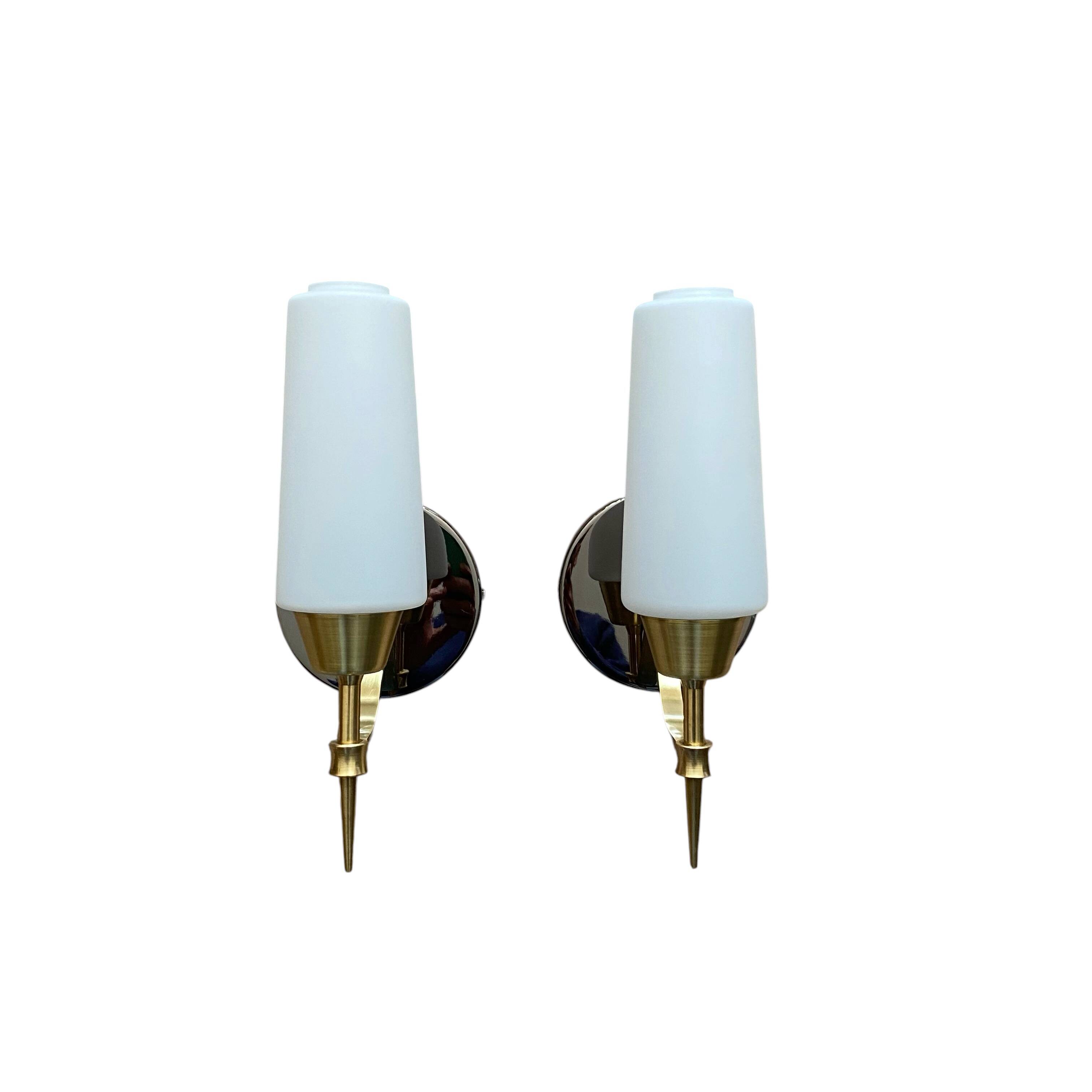 Pair of wall sconces in brass with white glass tulips.