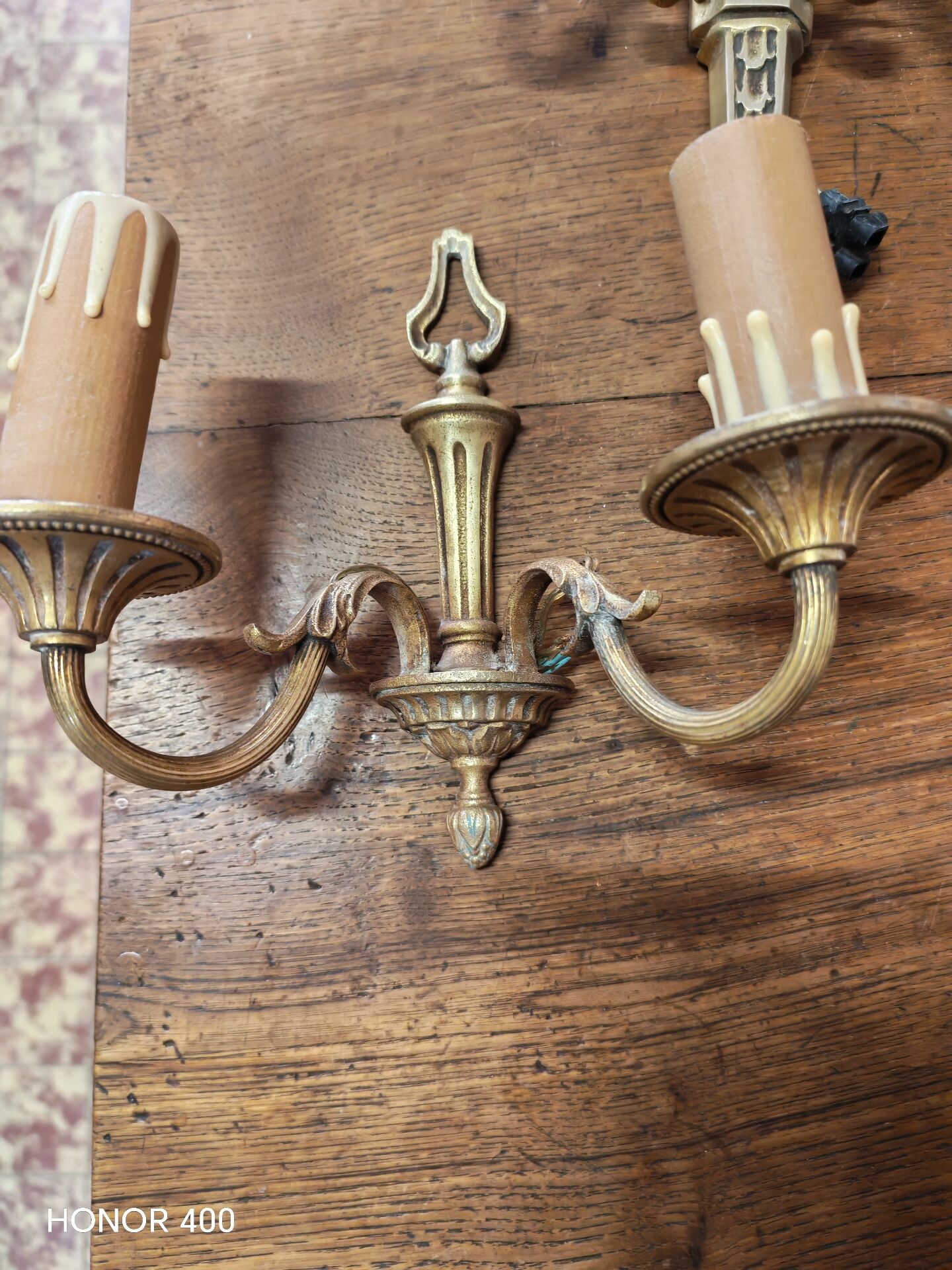 Two antique wall sconces in gilded bronze in the Louis XVI style.