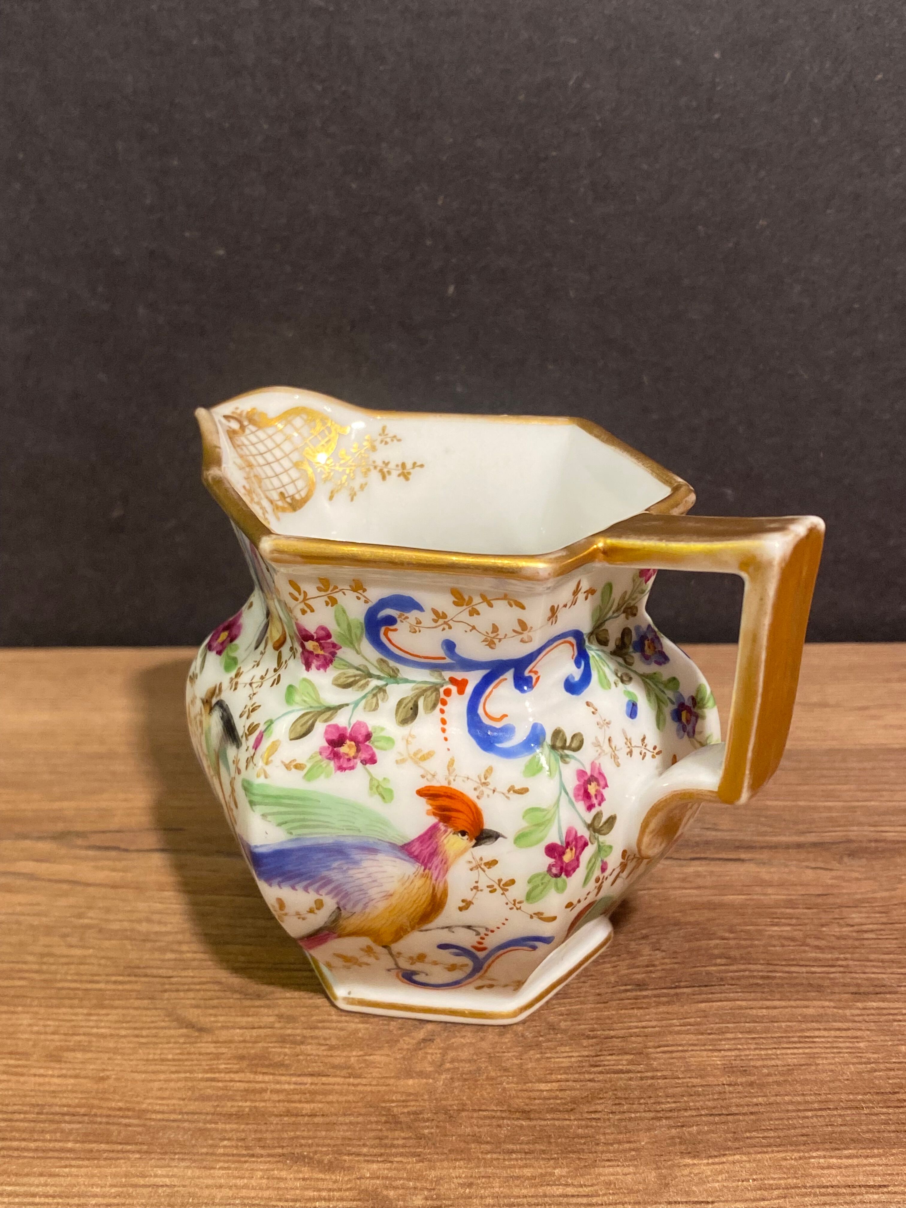 Old Paris porcelain milk jug with polychrome and gold bird floral decoration
