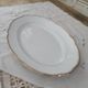 Oval plate in white Swiss porcelain double gilded border "VSK USC Viribus Unitis"