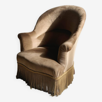 Fauteuil crapaud en velour à franges