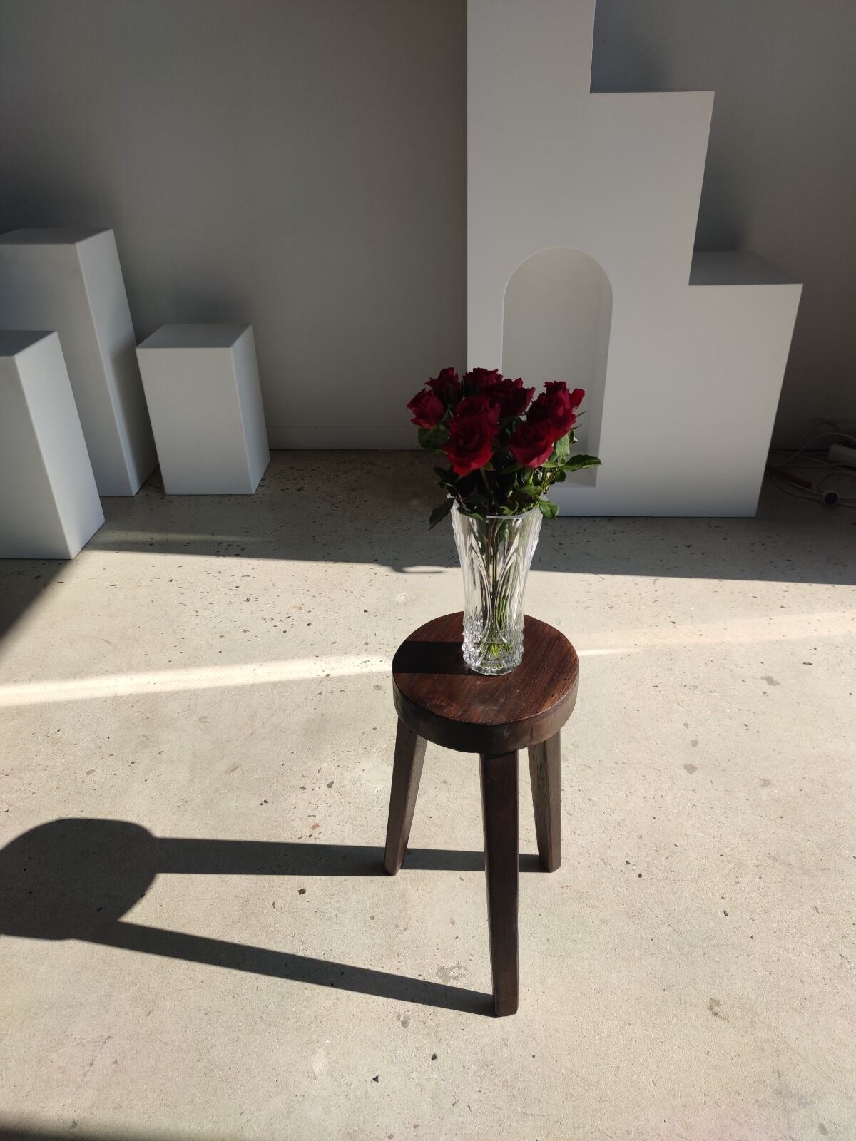 Small high tripod stool in brown solid wood