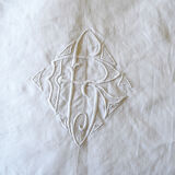 White sheet in monogrammed linen