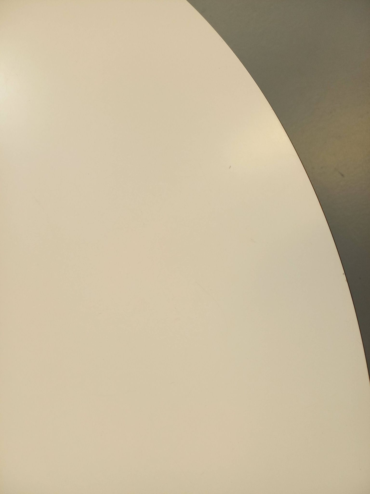 Vintage Eames round table for Vitra in white melamine, wood, and metal.
