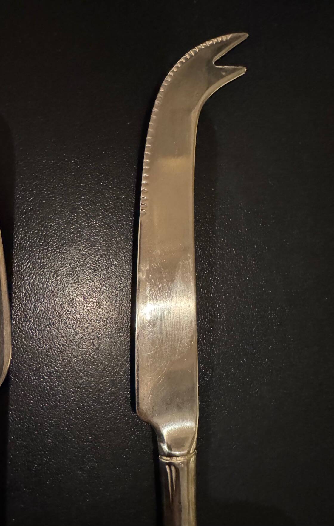 Golden metal cheese cutlery resembling bamboo