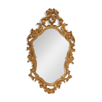 French Rococo or Baroque style facet-cut crest mirror in gilded carved wood