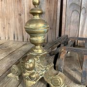 Pair of andirons and grates in cast iron and bronze with gilded grotesques, 17th century