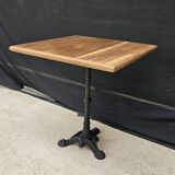 Bistro table with cast iron base and teak top