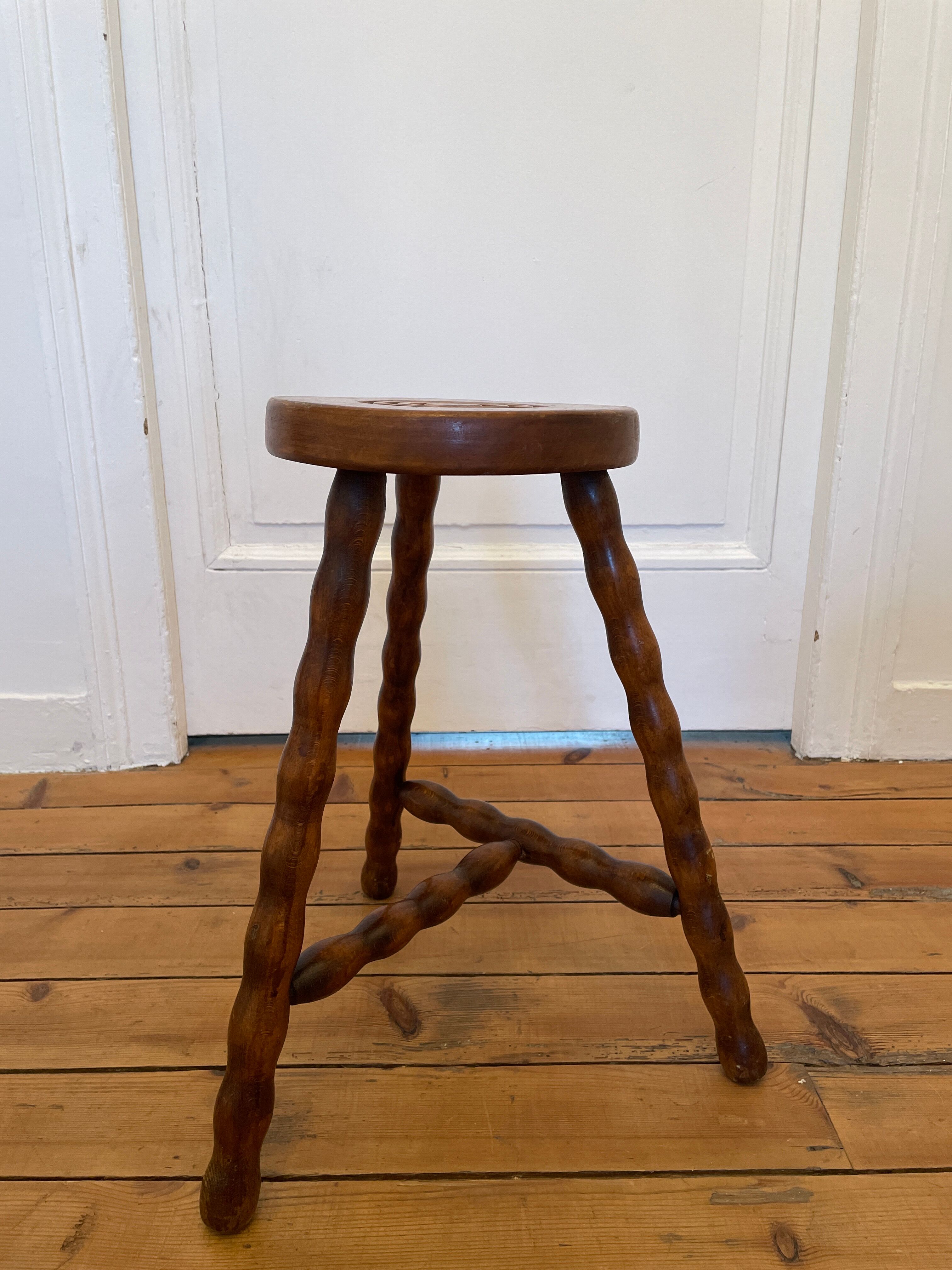 Old wooden tripod stool
