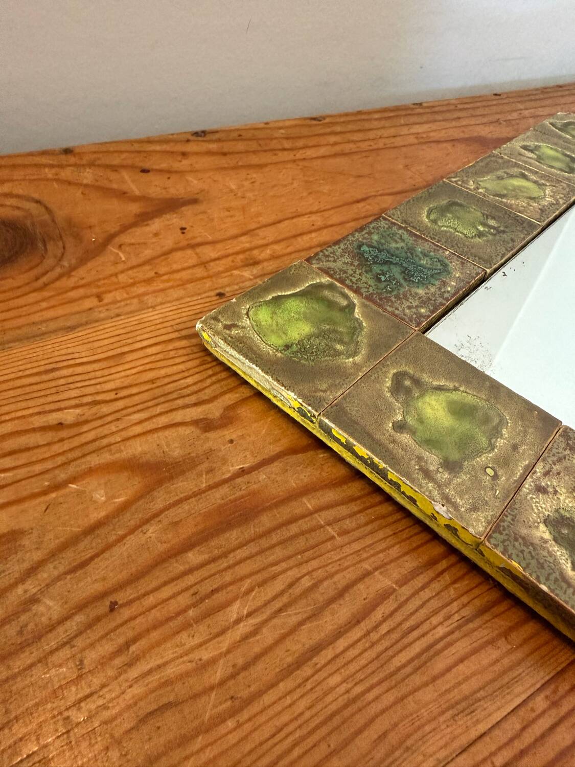Vintage 1960s green and brown glazed ceramic mirror.