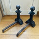 Pair of massive antique-style fire dogs in solid iron from the 20th century.